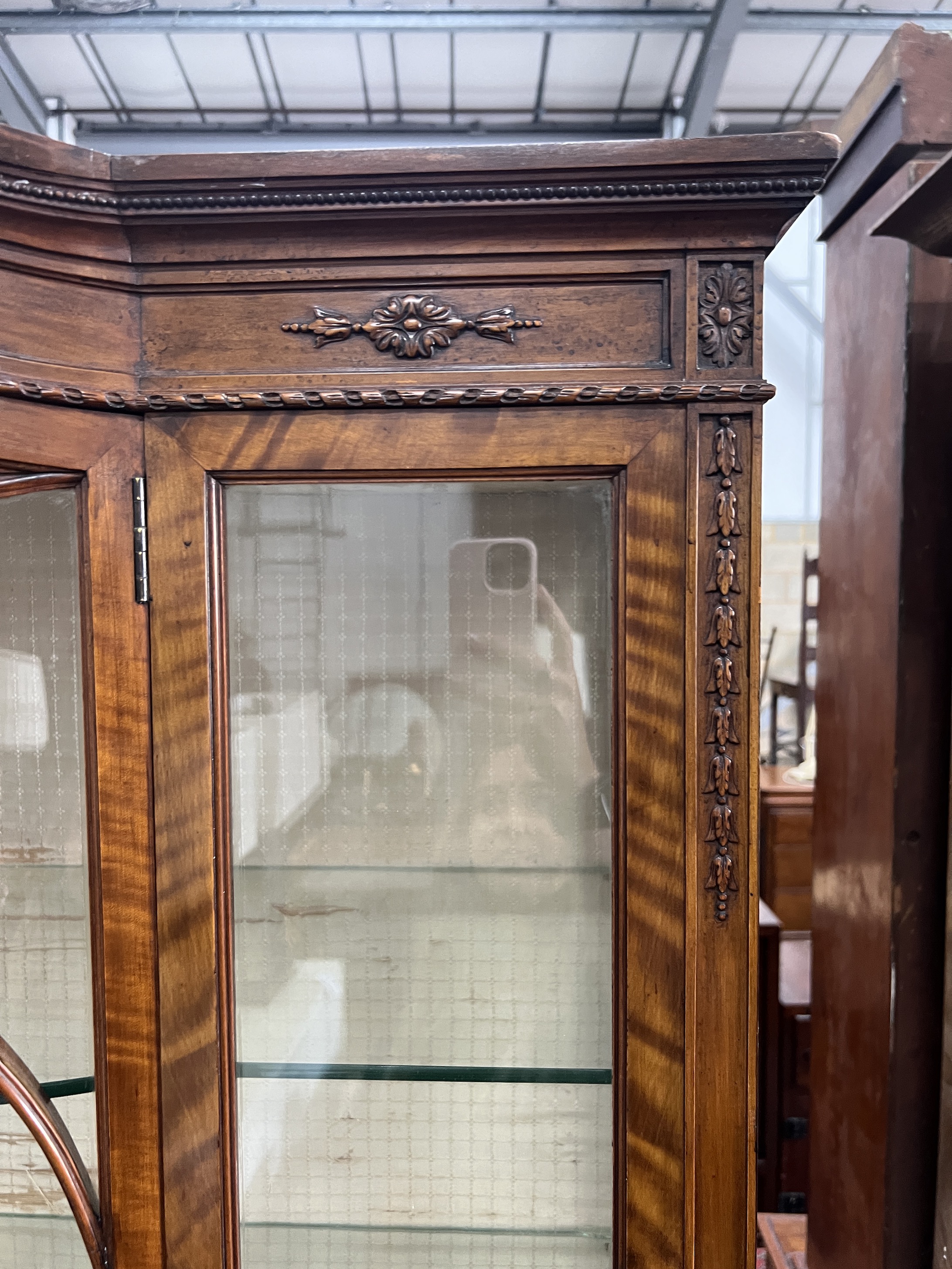 A 1920's Sheraton revival satinwood bowfront display cabinet, width 114cm, depth 42cm, height 211cm